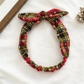 Detalle de diadema navideña a cuadros rojos y negros con motivos de copos y lazo anudado - Cuadros Amarillo Negro