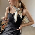 Classic black and white striped silk scarf tied as an elegant neck scarf for women - Off White