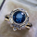 Vintage gold ring with deep blue sapphire center and diamond halo on velvet background - Cy804 / Size 5