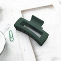 Detailed view of matte dark green hair claw clip with rectangular cutout on white frame - Dark Green