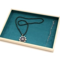Dark teal velvet jewelry display tray with floral beaded necklace and colorful gemstone bracelet - Empty Tray
