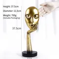 Abstract golden face sculpture on black round base, size 37.5cm height and 11.5cm diameter - Gold Large