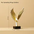 Abstract golden eagle sculpture with wings spread on a dark rectangular base - Gold & Silver-Eagle Spreading Wings