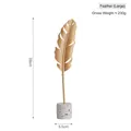 Golden metal feather sculpture on white terrazzo base, modern home decor 28cm height - Feather-Large