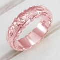 Macro shot of rose gold ring featuring detailed flower and leaf engraving and polished interior - US 5 / Rose Gold