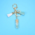 Detail of resin alphabet keychain with gold foil, white stones and dual color tassels - Letter I