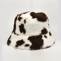 Detailed view of plush faux fur texture on this cow print winter bucket hat - M / Coffee