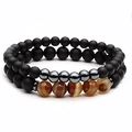 Macro shot of double-layer beaded bracelets with matte black and tiger eye stones - 2-Piece Matte Black Agate & Tiger Eye Elastic Bracelet Set