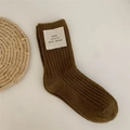 Army green thick wool mid-calf sock with a ribbed texture and white woven tag label - Caramel