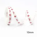 Close-up of 10mm white Christmas ribbon with red trees and Merry Christmas text - White Red Christmas Tree-5 Yards