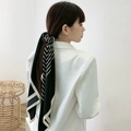 Elegant black and white striped silk scarf tied as a stylish hair accessory on a ponytail - Black