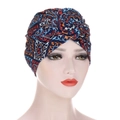 Detail of the navy blue ethnic print turban cap featuring a 3D fabric rose knot design - M / Navy Ethnic Geometric