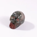Green and reddish-brown natural stone skull carving with a smooth polished finish - Bloodstone