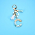 Detail of resin alphabet C keychain with gold foil, stones, and colorful tassels - Letter C