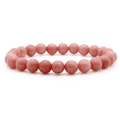 Bracciale minimalista con pietre rosa e perline rotonde lucide su sfondo bianco - Pietra rosa