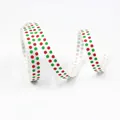 Close-up of 10mm white grosgrain ribbon featuring festive red and green polka dot patterns - White Red Green Polka Dots-5 Yards