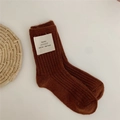 Brown ribbed wool blend socks with minimalist logo tag in a cozy vertical knit pattern - Brick Red
