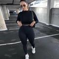 Close-up of black long sleeve crop top and high waist leggings for women's fitness - Black