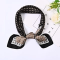 Detailed view of tied silk-like square scarf with geometric black and brown patterns - 70cm / Black