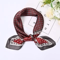 Detail view of 70cm square scarf with grey and red geometric patterns in a stylish knot - 70cm / Red
