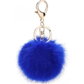 Macro shot of fluffy royal blue faux fur pompom with elegant light gold metal hardware - Sapphire Blue