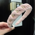 Detail of pink plush headband with woven gold metal chain texture and soft fabric finish - Pink