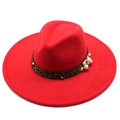 Detail of red wool fedora featuring leopard print band, pearls, and gold rivet accents - Red