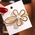 Close-up of golden floral hair clip with detailed pearl inlay and elegant petal design - No.5 Pearl Flower Hair Clip
