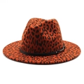 Detailed view of leopard print fedora hat featuring black leather band and silver buckle - M (56-58cm) / Rust red