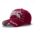 Detailed close-up of distressed embroidery and vintage worn fabric on wine red baseball cap - Burgundy