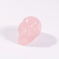 Hand-carved pink rose quartz skull figurine with a smooth polished finish - Rose Quartz