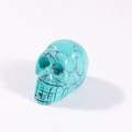 Skull figurine carved from turquoise stone with natural black spiderweb matrix - Turquoise Howlite