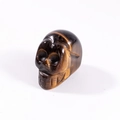Polished tiger eye stone skull carving with unique golden stripe texture - Tiger's Eye