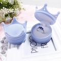 Light blue crown shaped velvet ring jewelry box with flower and frame background - Blue Crown