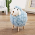 Handmade light blue wool felt sheep figurine with natural wooden legs for home decor - Blue