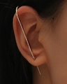 Close-up of golden crawler earrings with small white zirconia studs along the ear curve - Linear Style Gold (DZ-052)