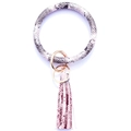 Close-up of pink and grey snake print leather keychain bangle with fringe tassel - Pink Snakeskin