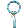 Detail of bright blue pop art leather bracelet keychain with gold ring and tassel - Cosmetics Print