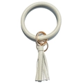 Detail of sage green lychee textured leather wristlet with golden ring and tassel charm - Gray