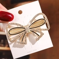 Close-up of elegant gold butterfly hair clip with rhinestones on a display card - No.8 Rhinestone Bow Hair Clip