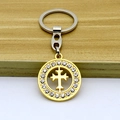 Golden cross pendant keychain with micro-pave crystals on a minimalist wooden surface - Keychain / Gold
