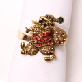 Golden Santa Claus napkin ring with colorful rhinestones on a white fabric napkin - Vintage Santa Claus