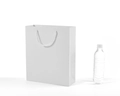 White card paper gift bag with white rope handles next to a bottle for size reference - Vertical 20*28*10cm