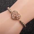 Adjustable gold heart bracelet with colorful cubic zirconia and braided strap on wrist - Colorful Rope With Copper Beads And Heart