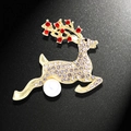 Golden jumping reindeer brooch with sparkling clear crystals, red accents and a white pearl - Jumping Reindeer with Artificial Pearl (YNCP713)