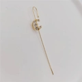 Golden moon-shaped cuff earring with sparkling white zircons on a white background - C-Shape Gold