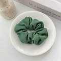 Elegant green organza scrunchie with ribbed texture on a white decorative plate - Dark Green Twill
