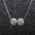 Silver necklace with dual interlocking hollow spheres set with sparkling green cubic zirconia - 2 Balls / Silver