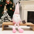 Pink Nordic Christmas gnome with long legs sitting on a wooden bench for holiday home decor - Long Leg Style / Pink
