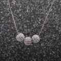 Détail macro d'un collier à trois sphères argentées orné de pavés de zircons cubiques - 6mm 3-Boules Argent